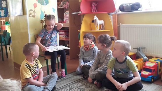  Grafika #0: Uczniowie klasy II SP czytają dzieciom z oddziału przedszkolnego.