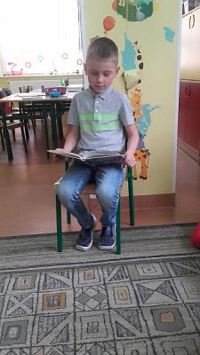  Grafika #4: Uczniowie klasy II SP czytają dzieciom z oddziału przedszkolnego.